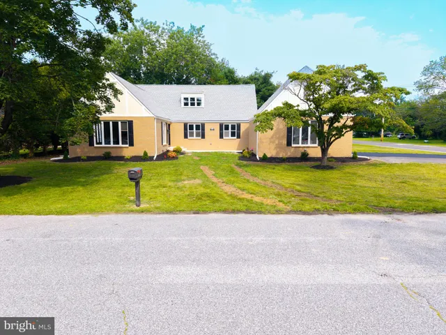 an aerial view of a house with swimming pool and a yard