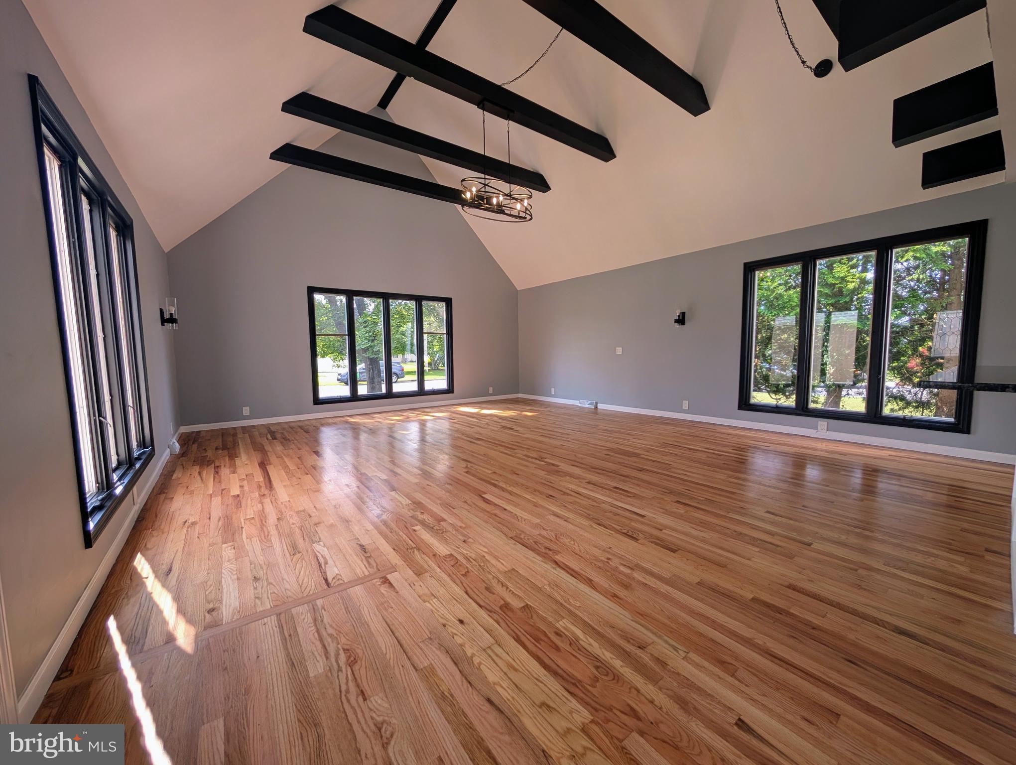 1037 Queens Road Vineland, NJ 08361 - Photo 17 of 40 a view of an empty room with wooden floor and a window