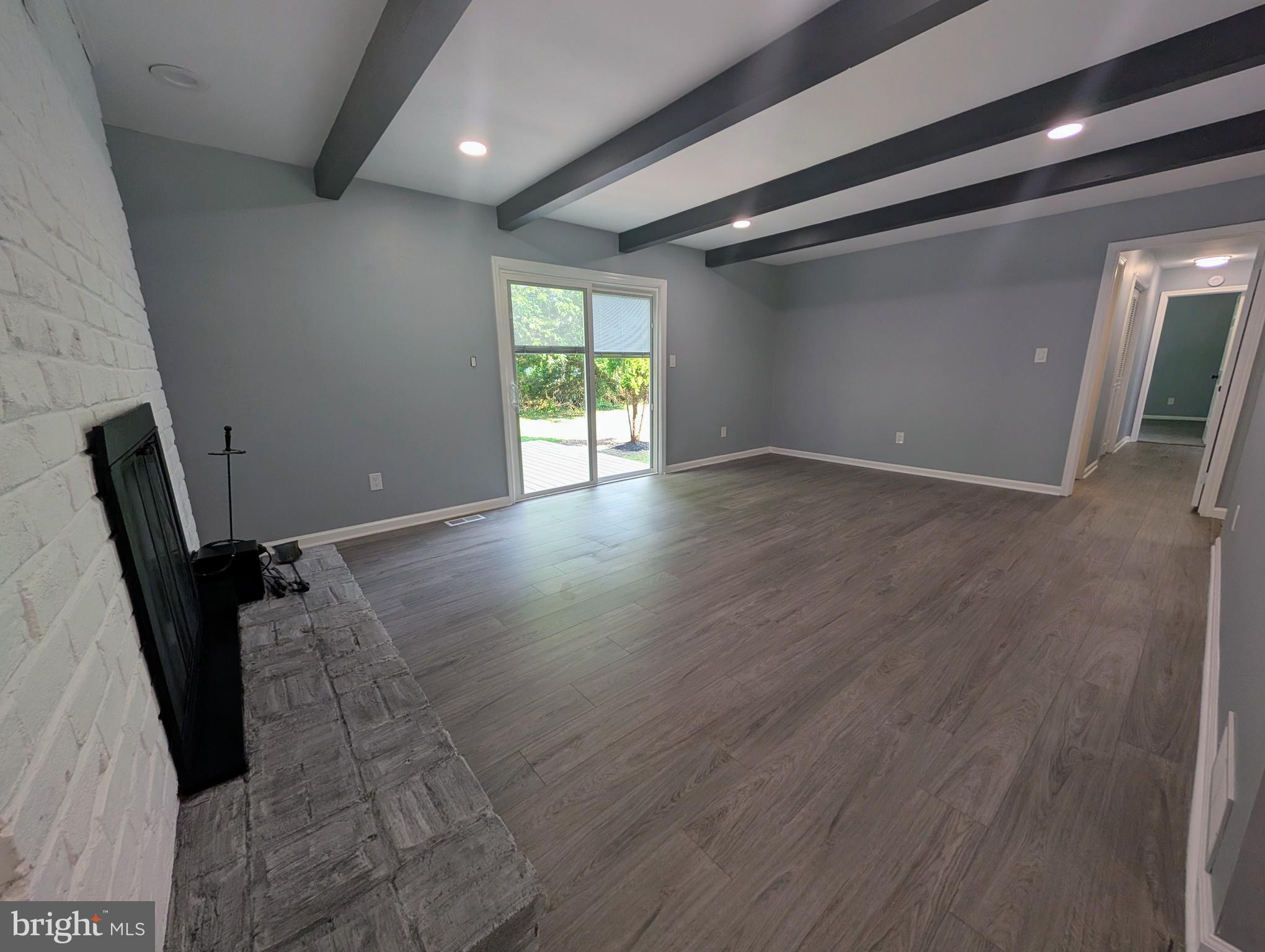 1037 Queens Road Vineland, NJ 08361 - Photo 23 of 40 an empty room with wooden floor and windows