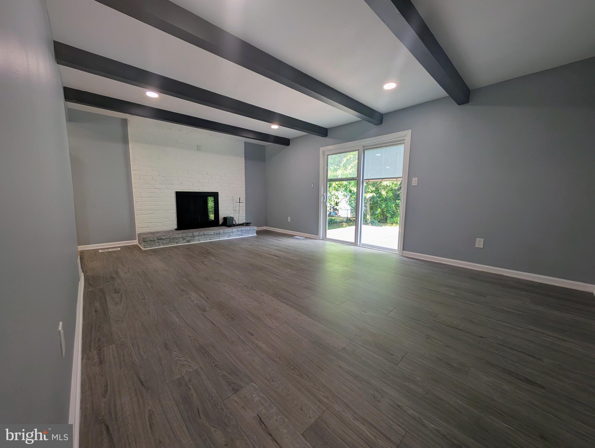 1037 Queens Road Vineland, NJ 08361 - Photo 24 of 40 an empty room with wooden floor and windows
