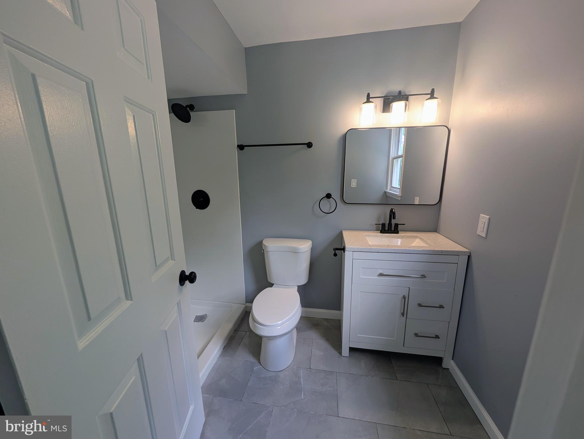 1037 Queens Road Vineland, NJ 08361 - Photo 30 of 40 a bathroom with a toilet sink and mirror