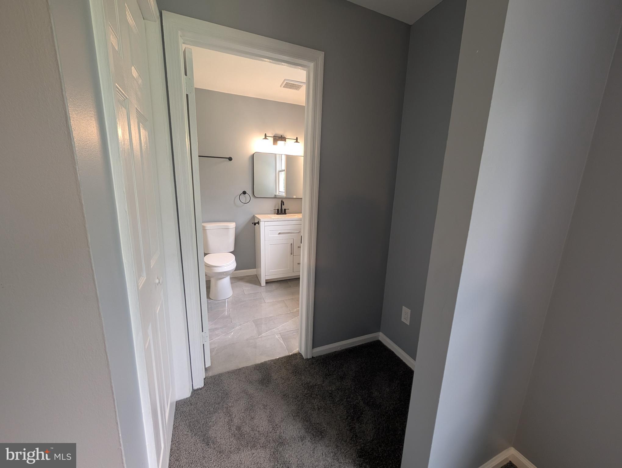 1037 Queens Road Vineland, NJ 08361 - Photo 31 of 40 a view of a bathroom from a hallway