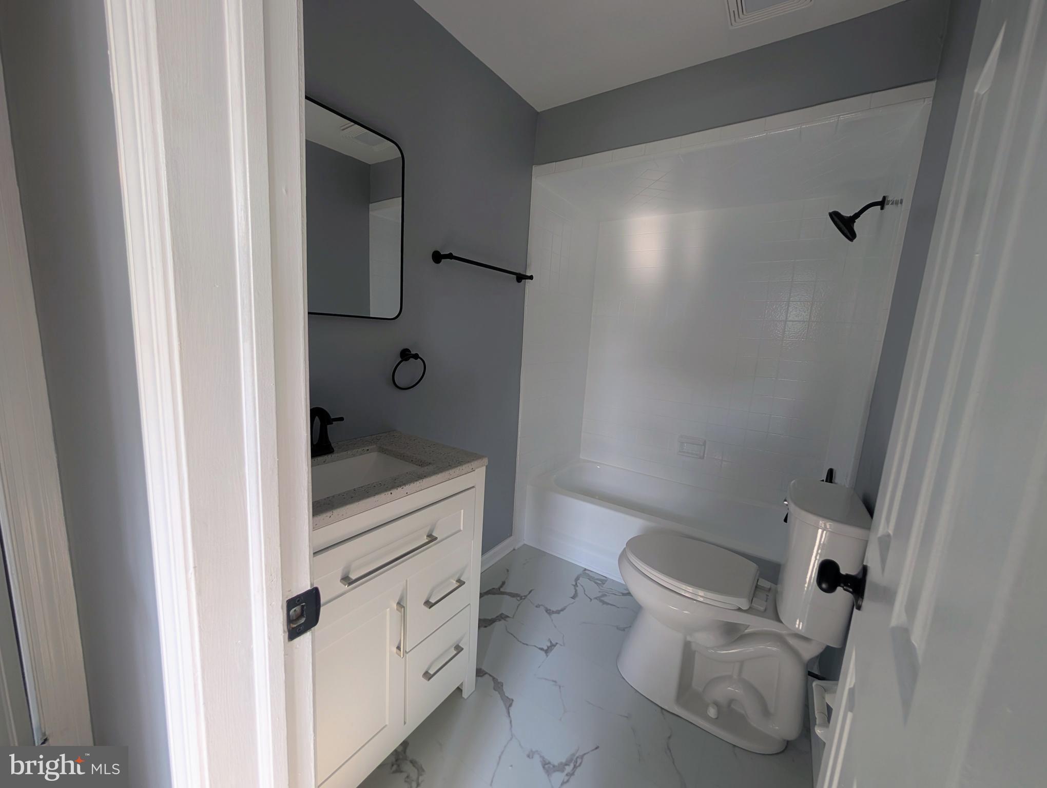 1037 Queens Road Vineland, NJ 08361 - Photo 38 of 40 a bathroom with a granite countertop sink a toilet and shower