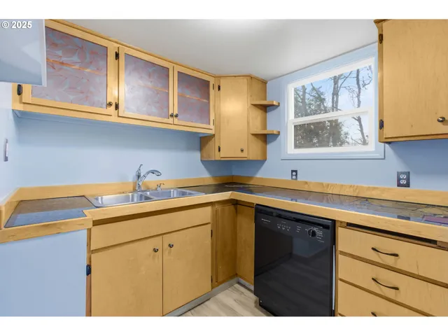 a kitchen with a sink and cabinets