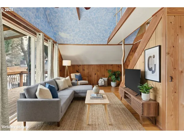 a living room with furniture fireplace and a large window