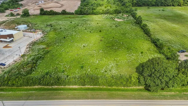 a view of a field of grass and trees