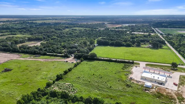 an aerial view of a houses with a yard