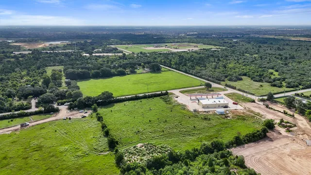 an aerial view of a houses with a yard