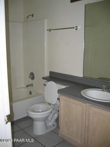 a bathroom with a toilet a sink and shower
