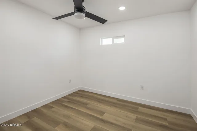 an empty room with a empty space and a ceiling fan