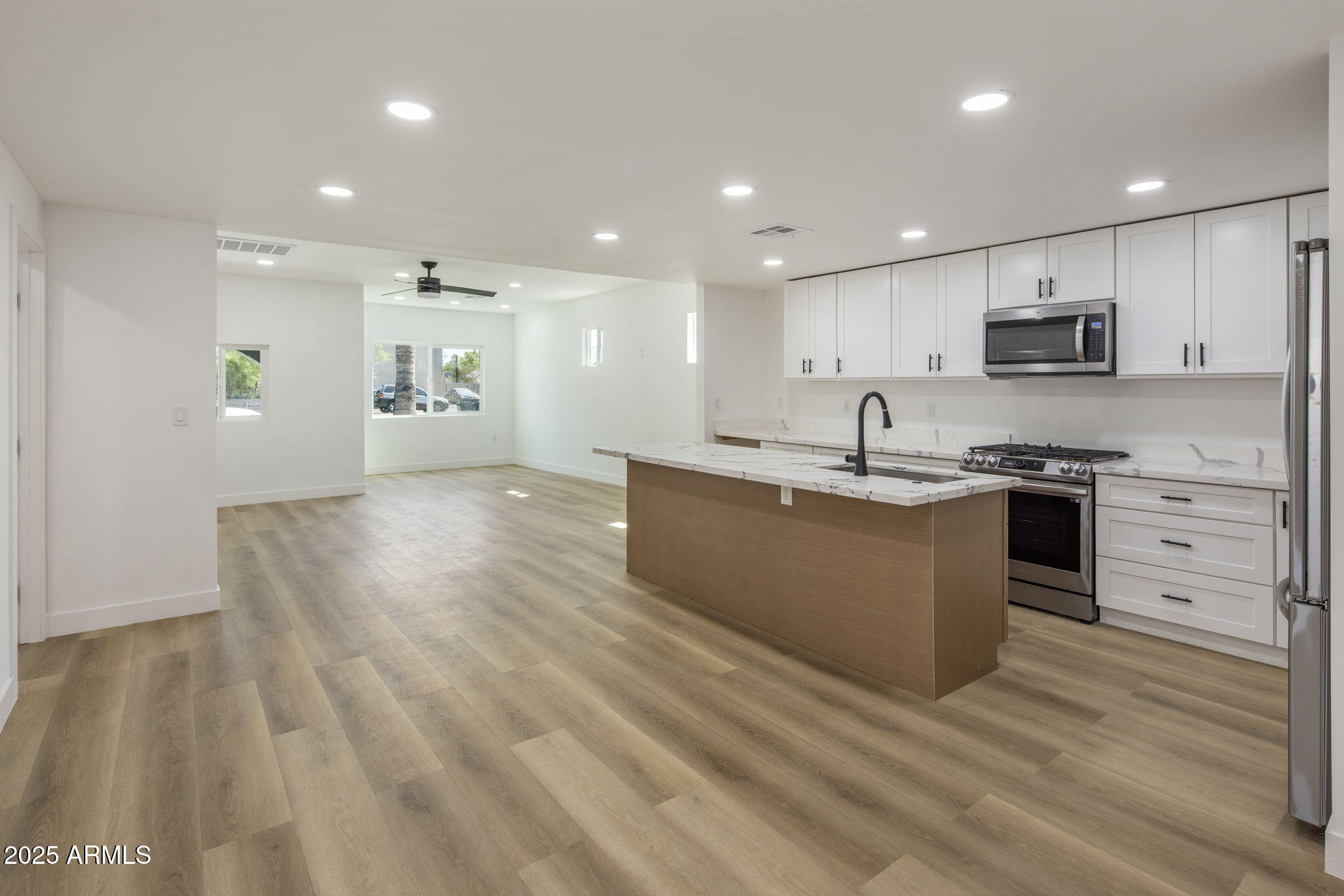 1440 East Pierce Street Phoenix, AZ 85006 - Photo 7 of 20 a kitchen with stainless steel appliances granite countertop a sink dishwasher a stove and a refrigerator with wooden floor