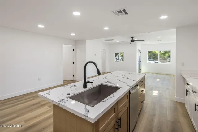 a kitchen that has a sink a stove and a table in it