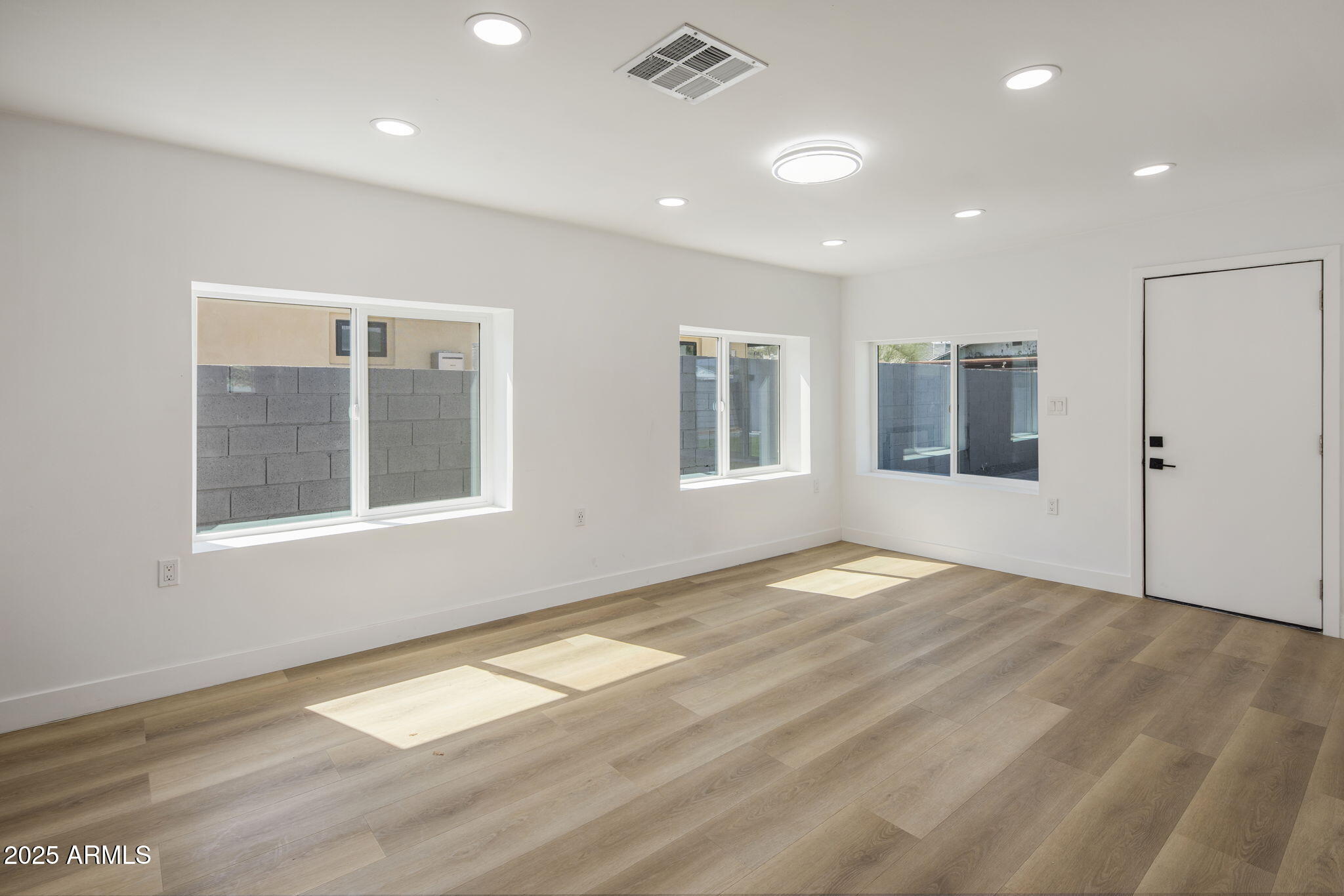 1440 East Pierce Street Phoenix, AZ 85006 - Photo 9 of 20 a view of empty room with wooden floor and fan