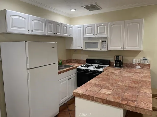 a kitchen with a stove and a refrigerator