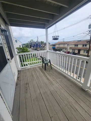 a view of balcony with wooden floor