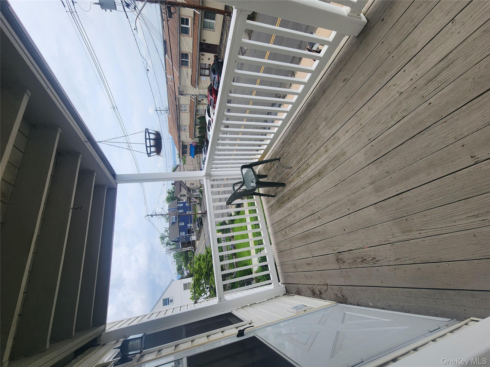a view of balcony with wooden floor