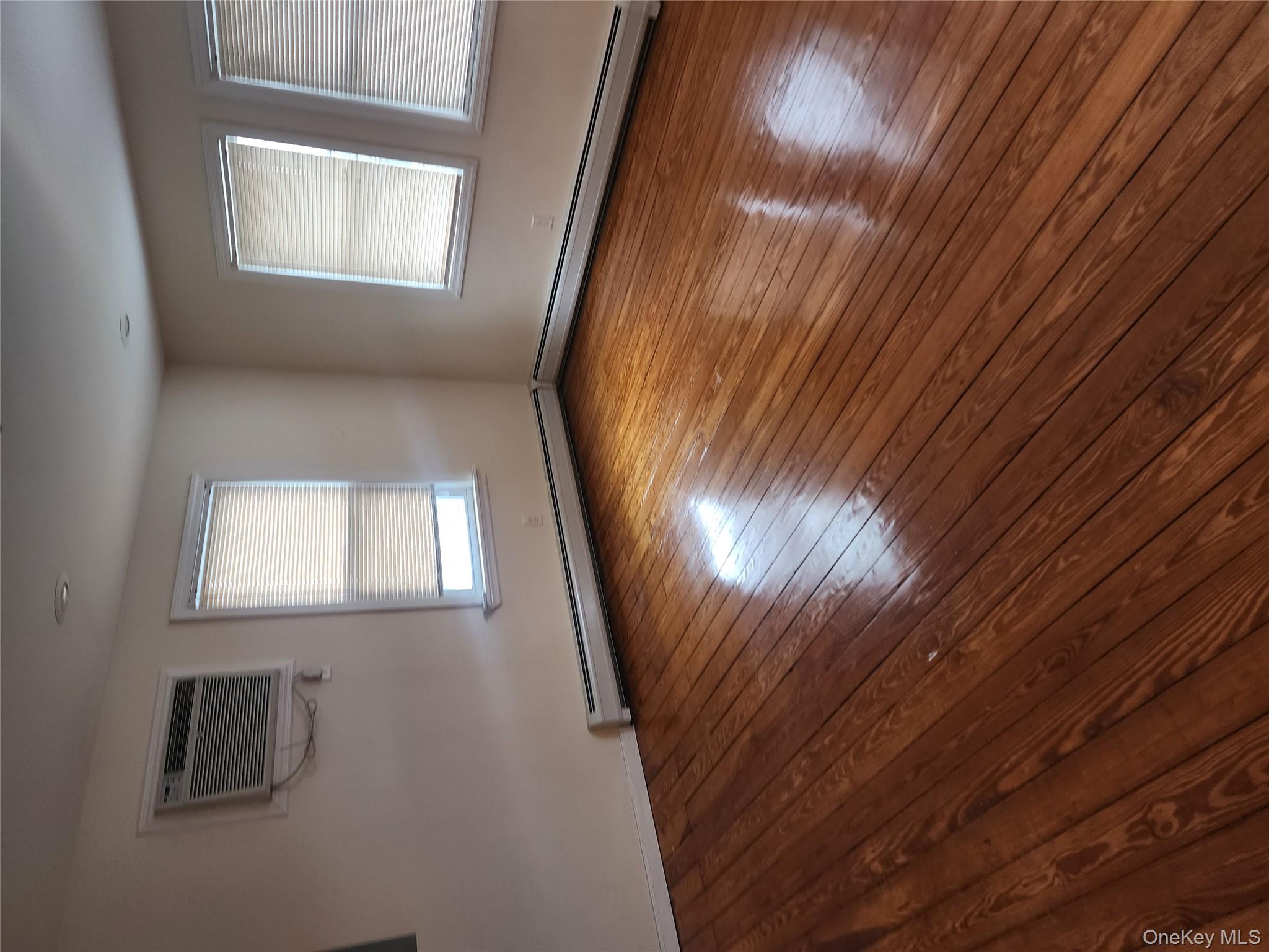 632 Piermont Avenue, Unit 2 Piermont, NY 10968 - Photo 2 of 31 an empty room with wooden floor and windows