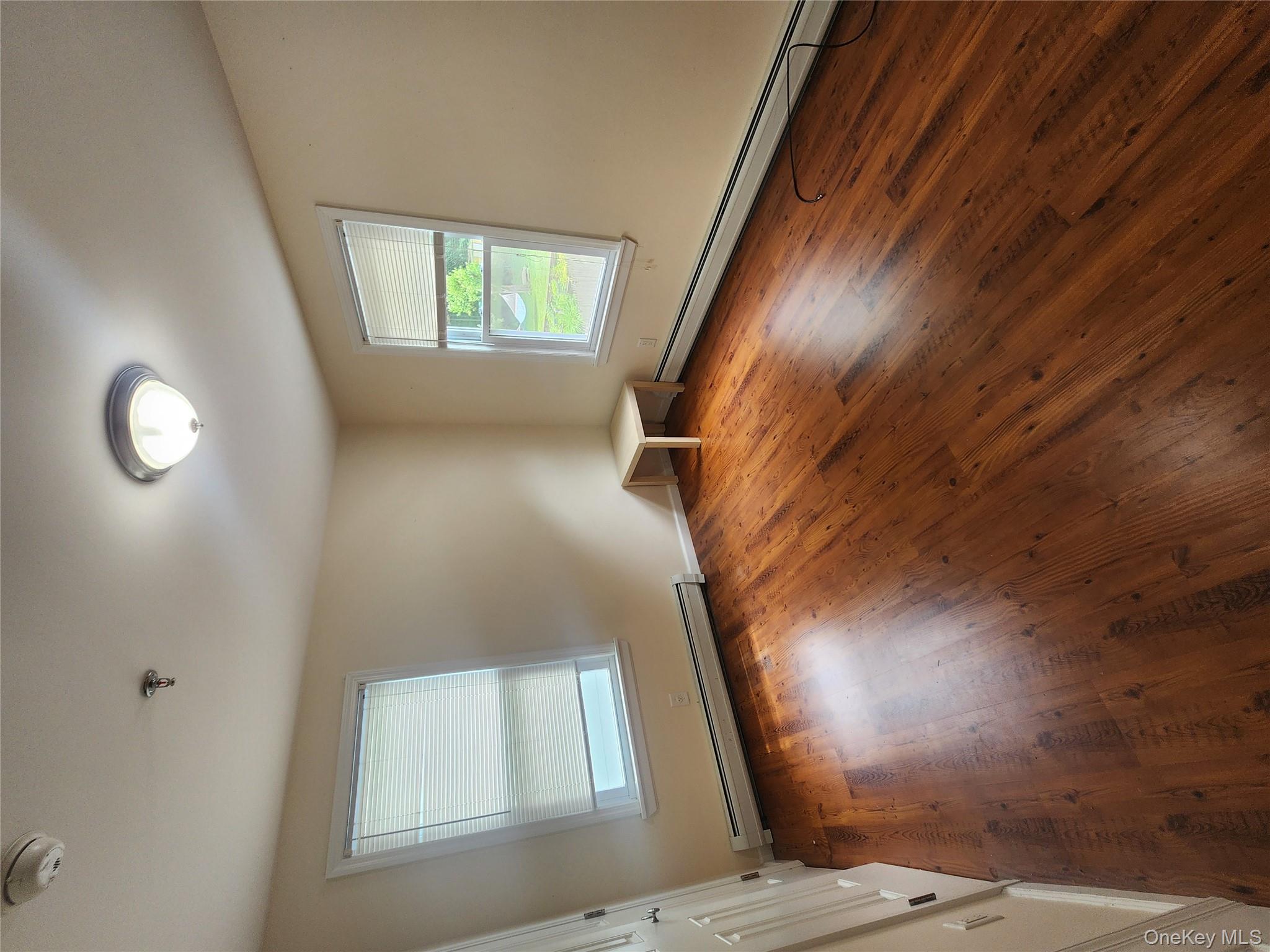 632 Piermont Avenue, Unit 2 Piermont, NY 10968 - Photo 22 of 31 an empty room with wooden floor and windows