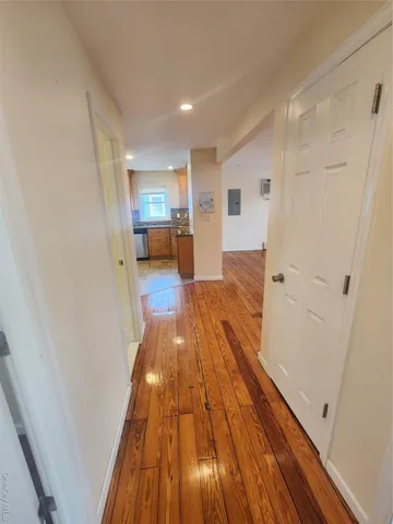 a view of hallway with wooden floor