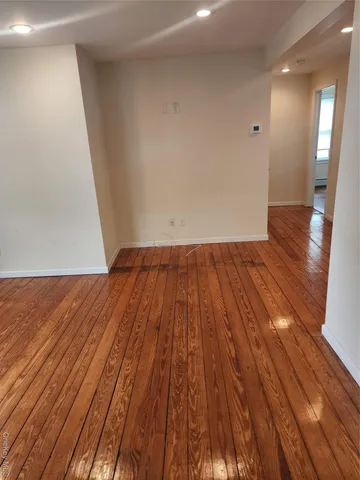 a view of a room with wooden floor and staircase