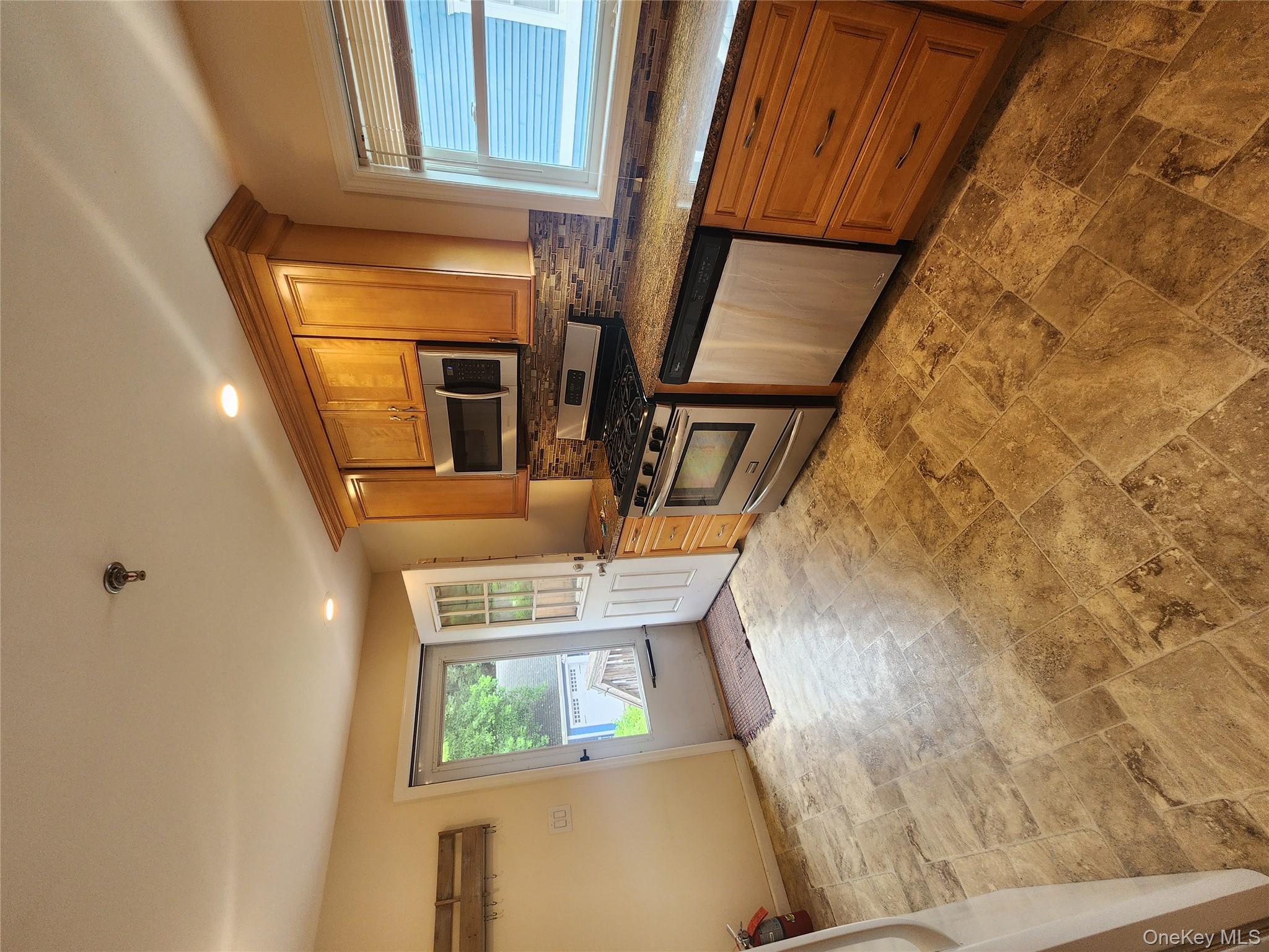 632 Piermont Avenue, Unit 2 Piermont, NY 10968 - Photo 5 of 31 a kitchen with stainless steel appliances granite countertop a stove sink and microwave