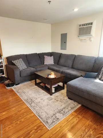 a living room with a couches and painting on the wall