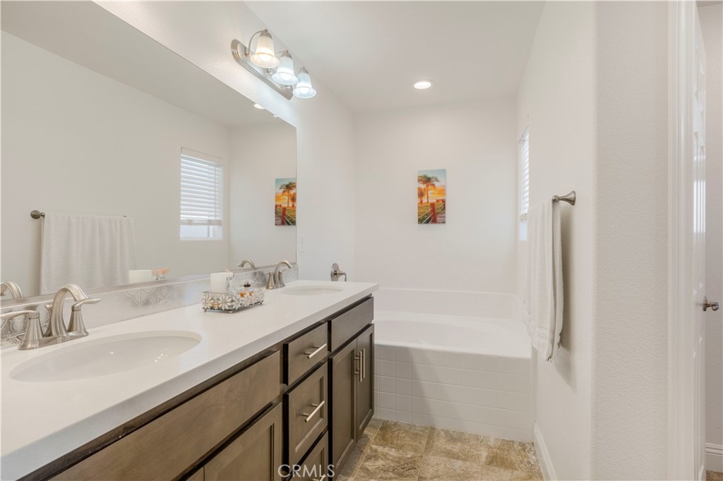 4368 Ladera Drive Guadalupe, CA 93434 - Photo 21 of 39 a bathroom with a sink tub and a mirror