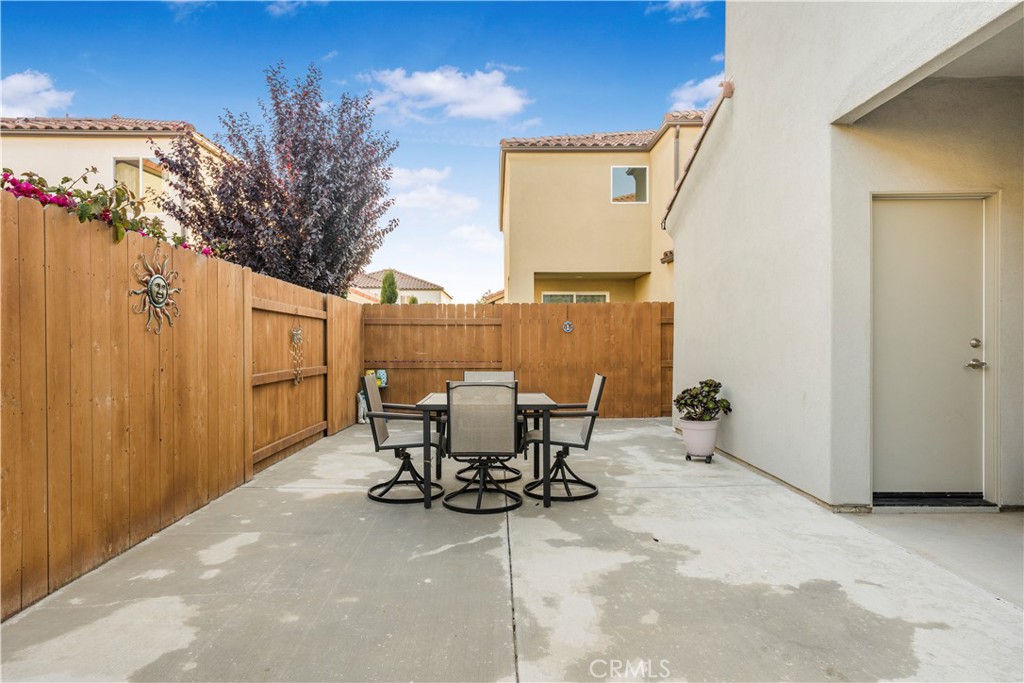4368 Ladera Drive Guadalupe, CA 93434 - Photo 26 of 39 a view of a patio with table and chairs and potted plants with wooden fence