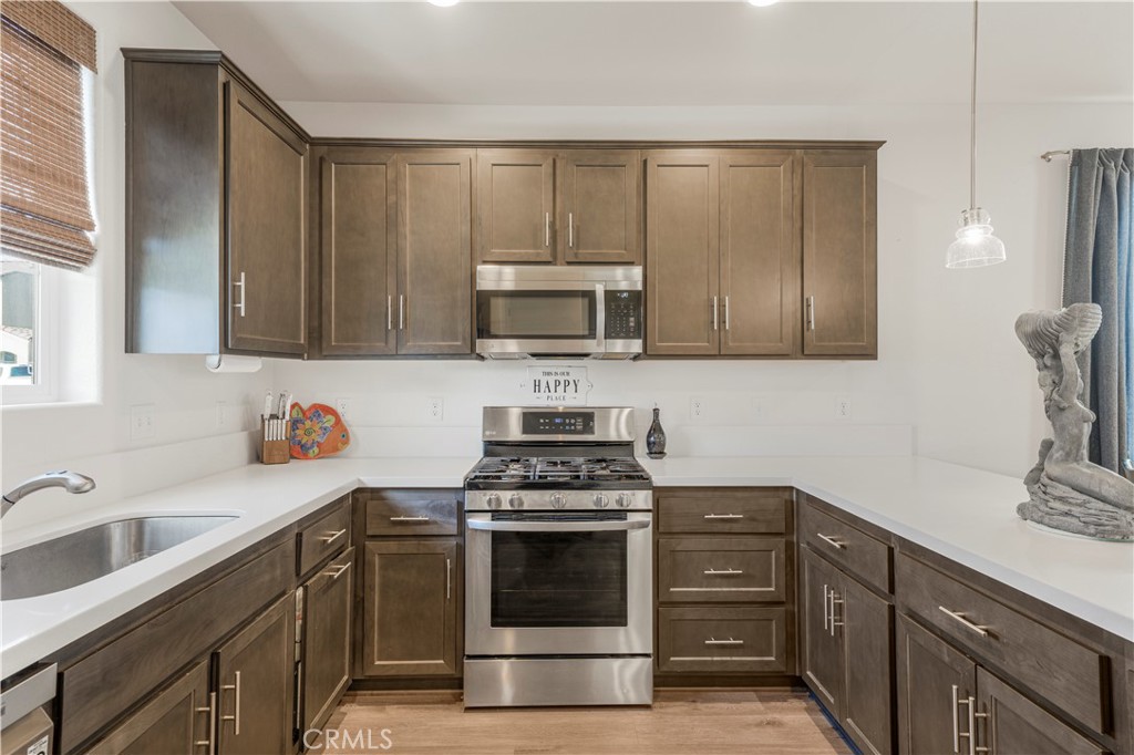 4368 Ladera Drive Guadalupe, CA 93434 - Photo 6 of 39 a kitchen with a sink stove and microwave