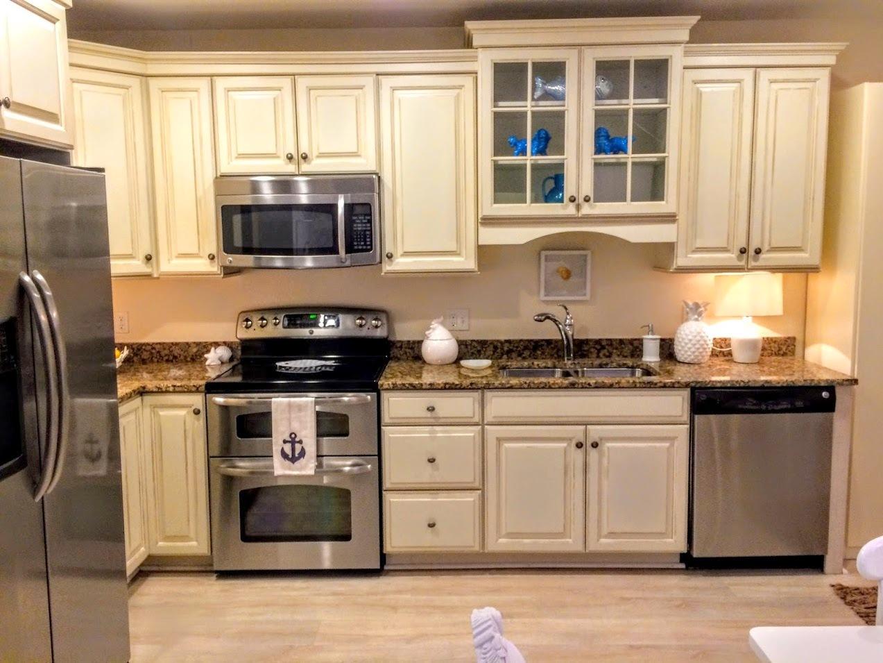 89 Lewis Bay Road, Unit 201 Hyannis, MA 02601 - Photo 4 of 17 a kitchen with stainless steel appliances granite countertop a stove a sink and a refrigerator