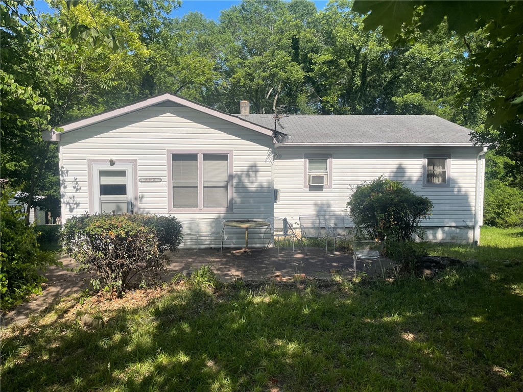 303 Butler Street Westminster, SC 29693 - Photo 1 of 7 A quaint residence with siding and a compact patio area nestled amidst green foliage.