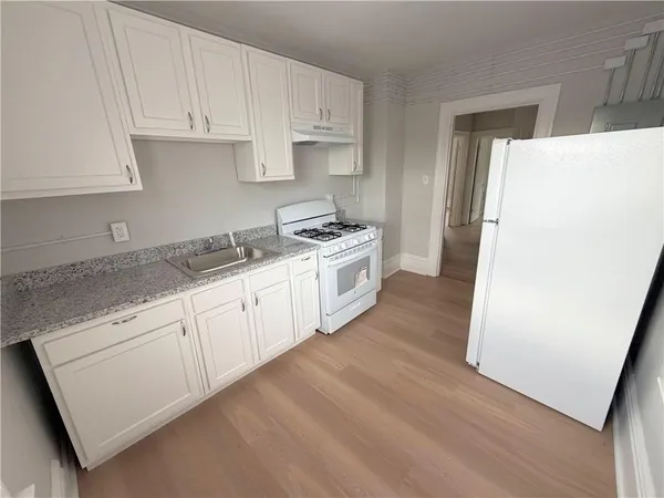 a kitchen with a white cabinets and white appliances