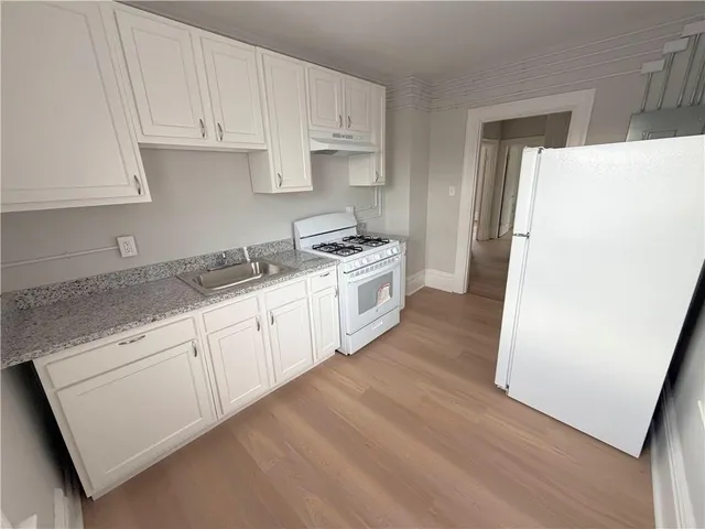 a kitchen with a white cabinets and white appliances