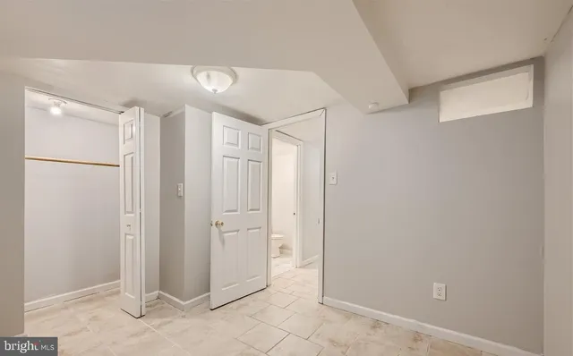 a large white kitchen with cabinets and stainless steel appliances