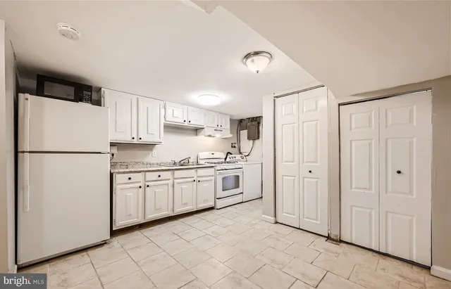 a kitchen with stainless steel appliances granite countertop a stove and a refrigerator