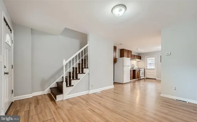 a view of a kitchen with furniture and wooden floor