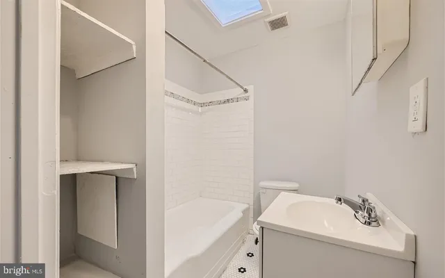a view of a livingroom with wooden floor washer and dryer