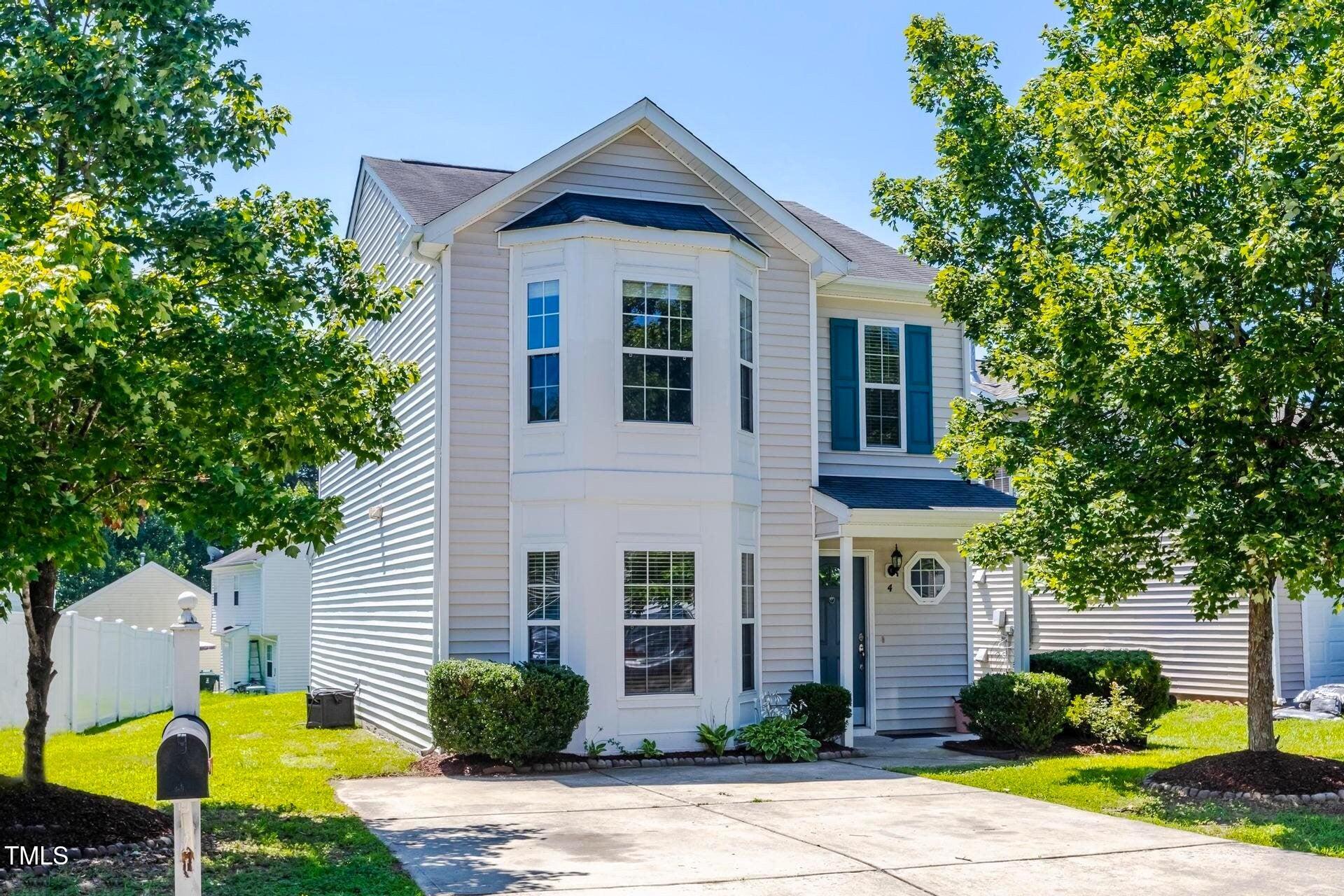 4 Intrepid Court Durham, NC 27703 - Photo 1 of 25 a front view of a house with garden