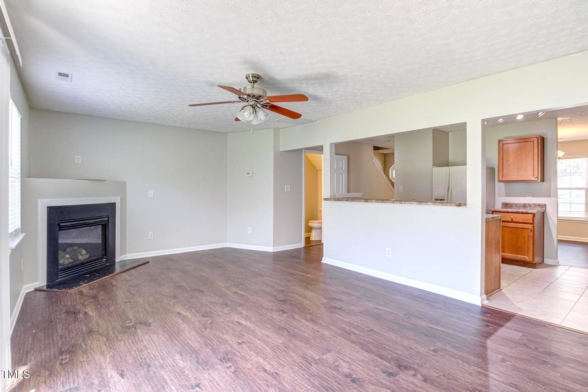 4 Intrepid Court Durham, NC 27703 - Photo 9 of 25 a view of an empty room with a fireplace and a window