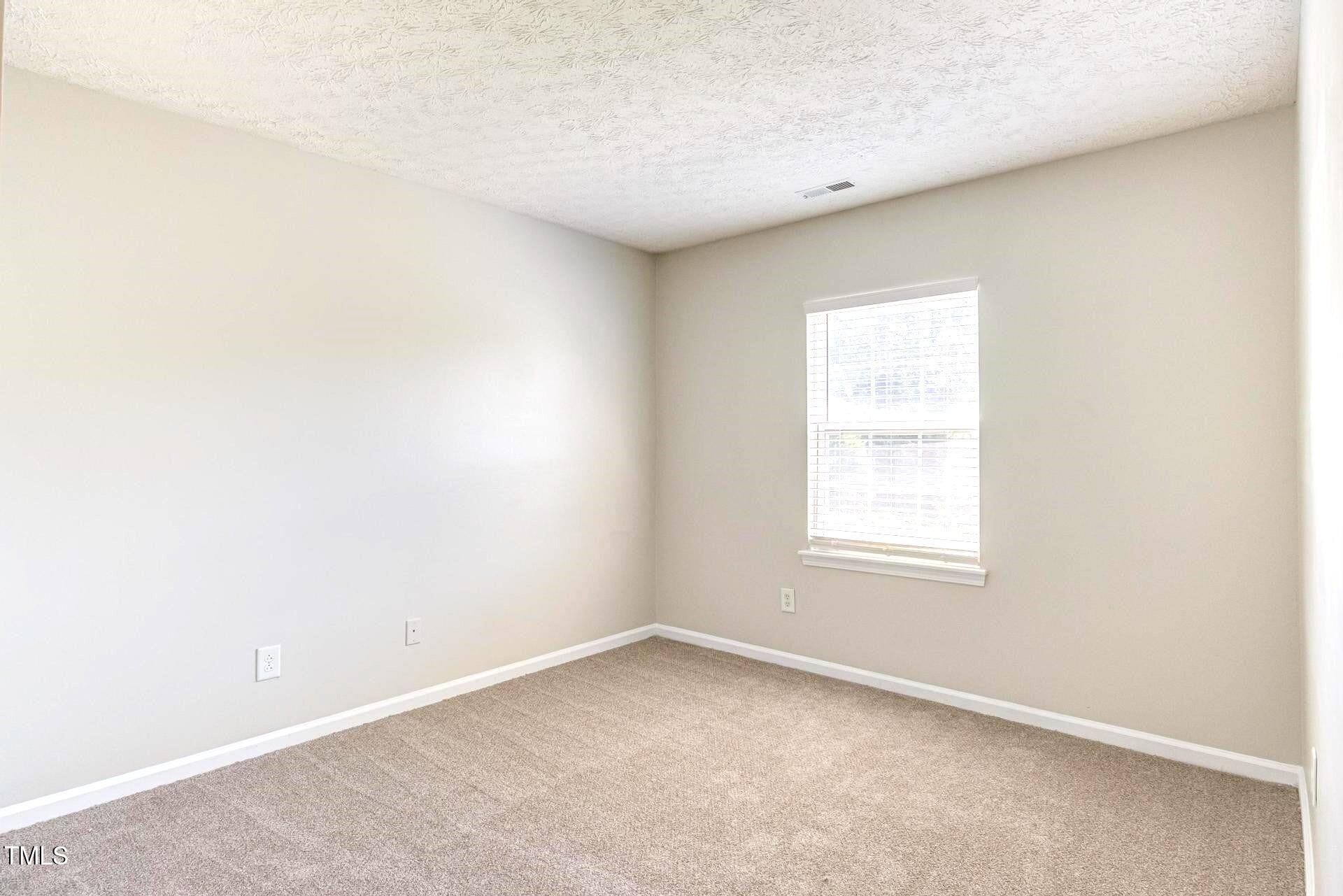 4 Intrepid Court Durham, NC 27703 - Photo 15 of 25 an empty room with a window