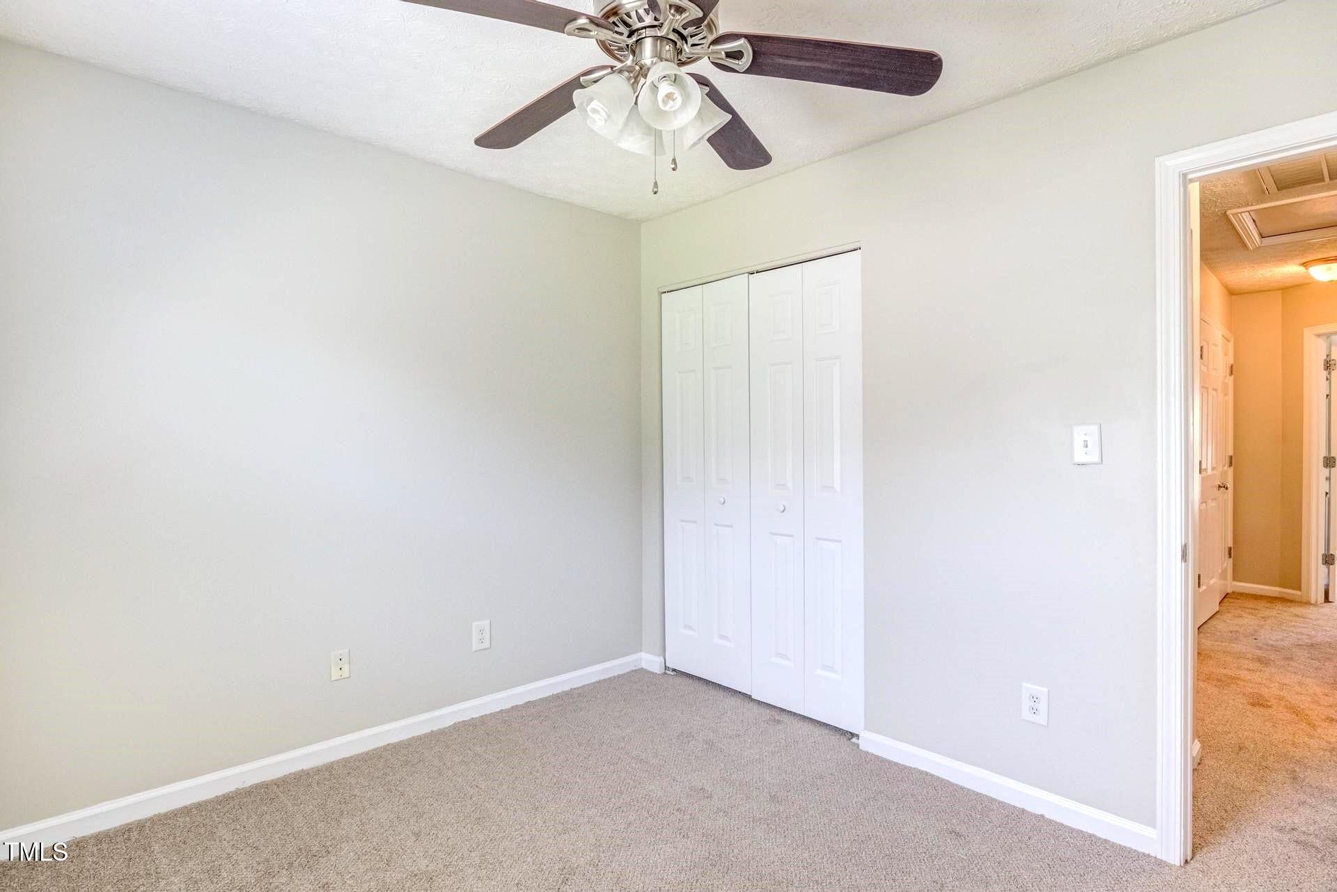 4 Intrepid Court Durham, NC 27703 - Photo 19 of 25 an empty room and chandelier fan