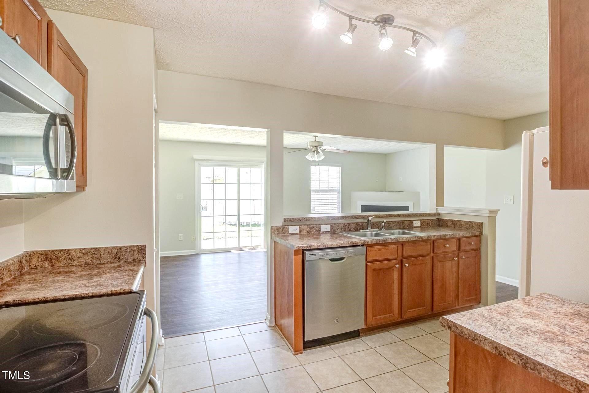 4 Intrepid Court Durham, NC 27703 - Photo 7 of 25 a kitchen with stainless steel appliances granite countertop a stove and a sink