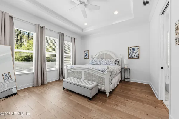 a bedroom with a bed and a large window