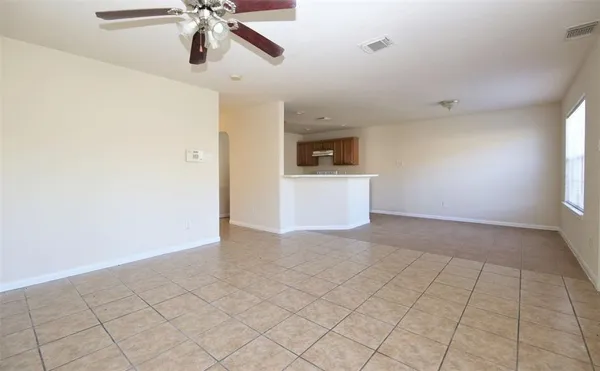 a view of a livingroom with a ceiling fan and window