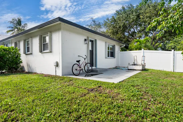 a front view of house with yard and outdoor seating