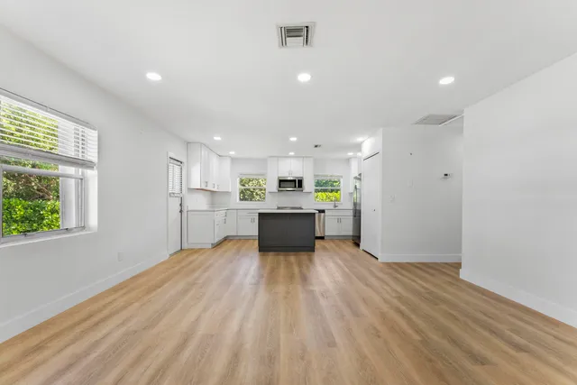 a view of kitchen with a refrigerator and wooden floor