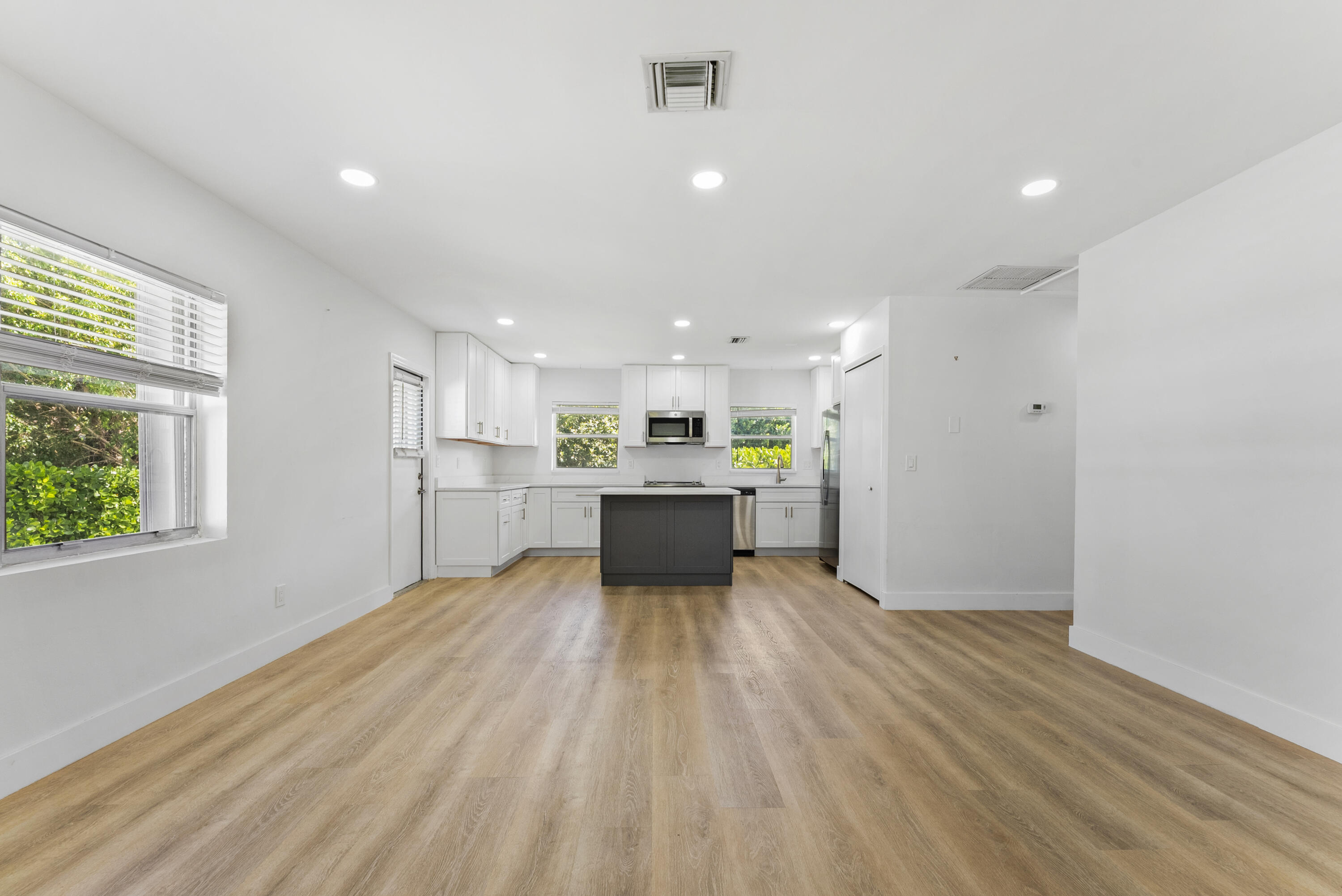 632 Allen Avenue, Unit 1 Delray Beach, FL 33483 - Photo 4 of 16 a view of kitchen with a refrigerator and wooden floor