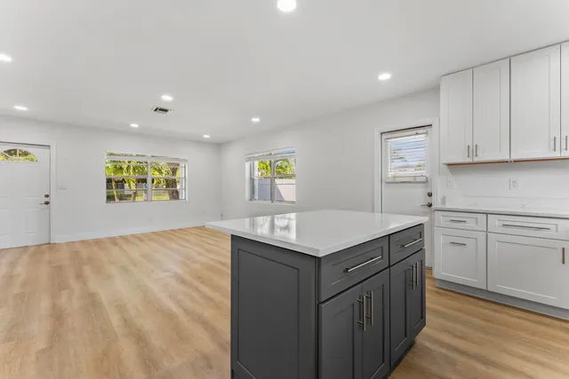 a kitchen with stainless steel appliances granite countertop a sink and a stove top oven