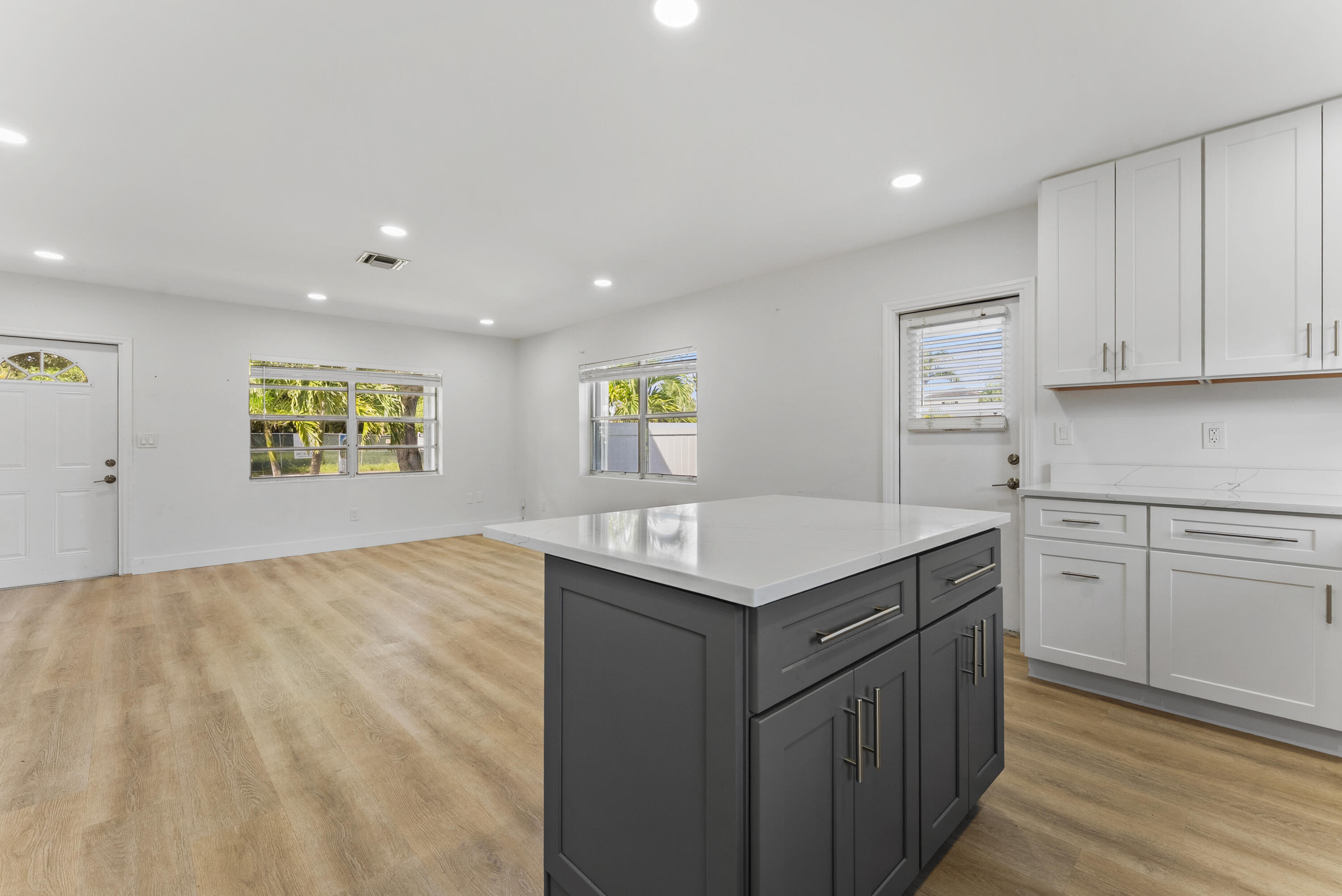 632 Allen Avenue, Unit 1 Delray Beach, FL 33483 - Photo 6 of 16 a kitchen with stainless steel appliances granite countertop a sink and a stove top oven