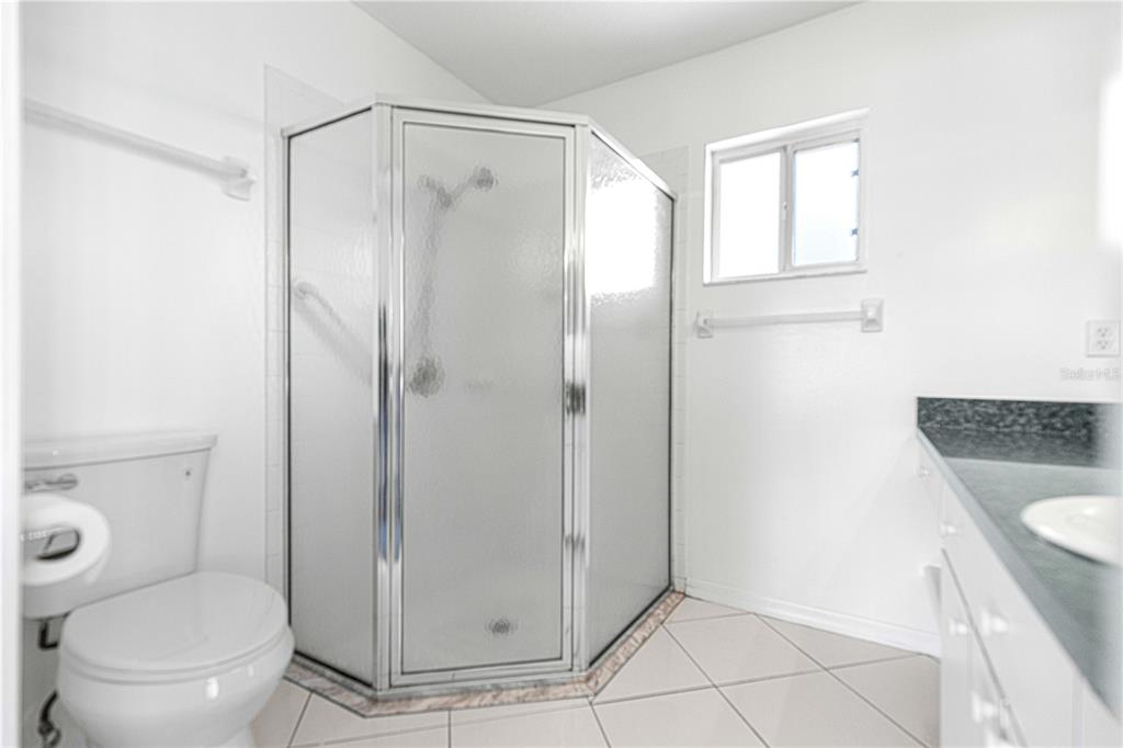 9840 Southwest 63rd Court Ocala, FL 34476 - Photo 11 of 49 a bathroom with a granite countertop shower and a toilet